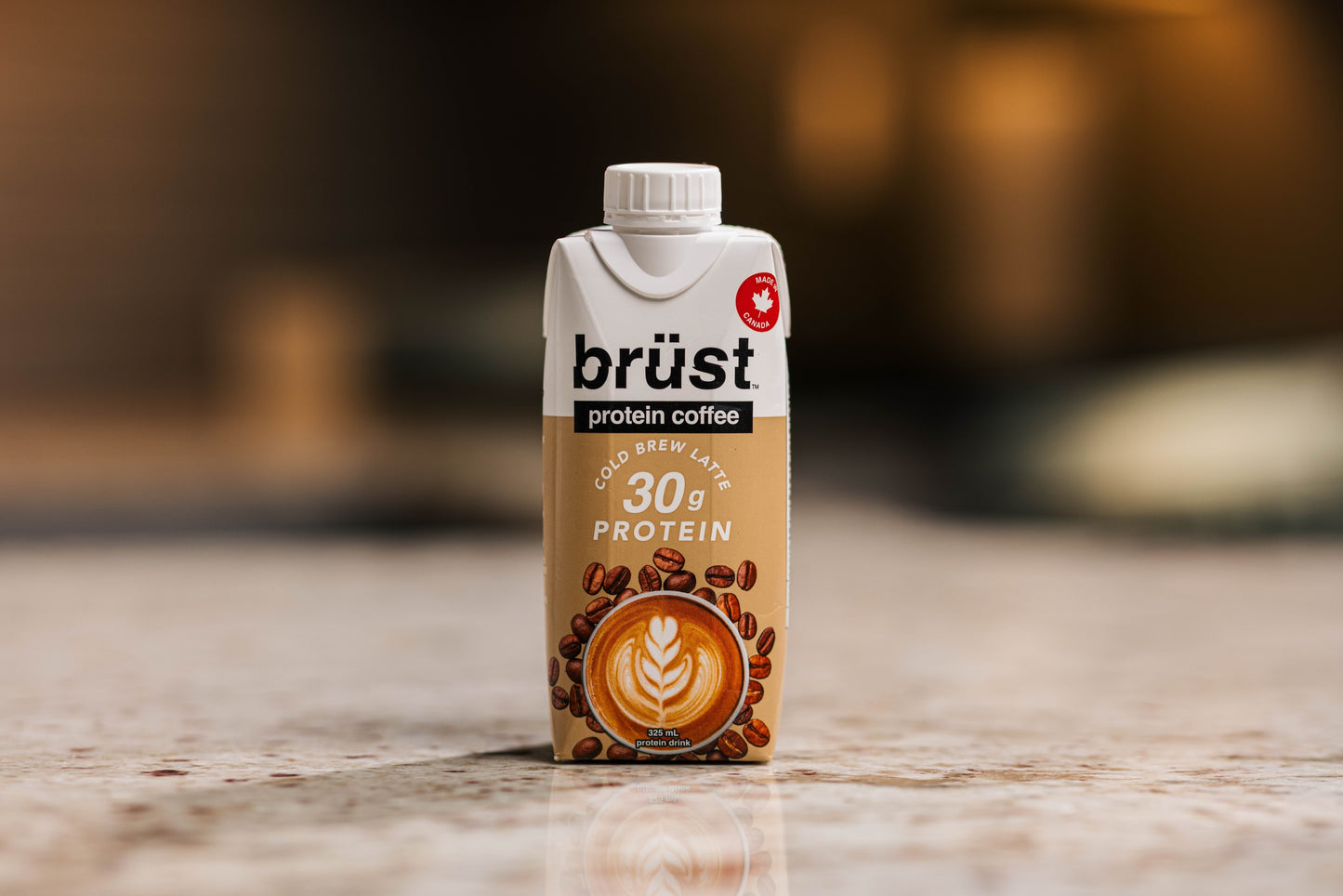 brüst cold brew latte protein coffee bottle on a kitchen counter, made in Canada badge